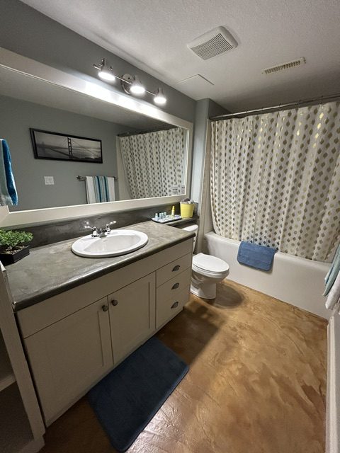 Clean bathroom with vanity and large mirror